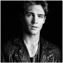 Black & white photo of a young man in a leather jacket